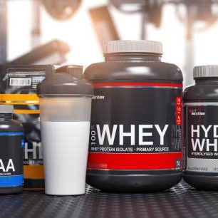 Sports nutrition supplements and chemistry for bodybuilding in gym. Whey protein casein, bcaa, creatine cans. 3d illustration